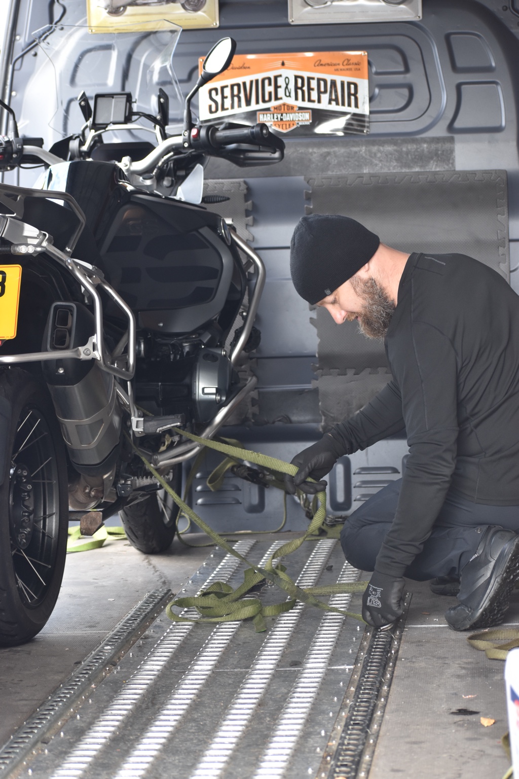 Greg securing a motorcycle inside the transport van